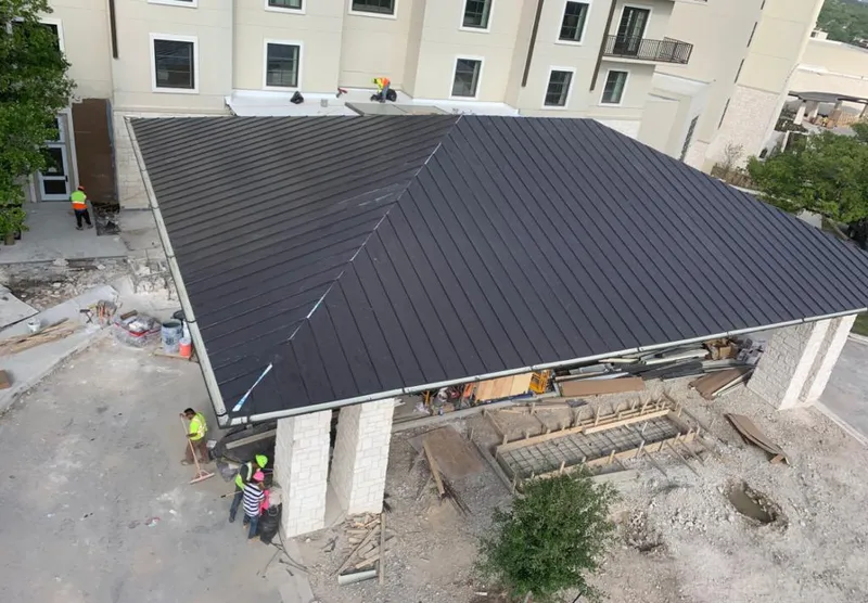 Metal roofing installation team working on a commercial building in Discovery Bay
